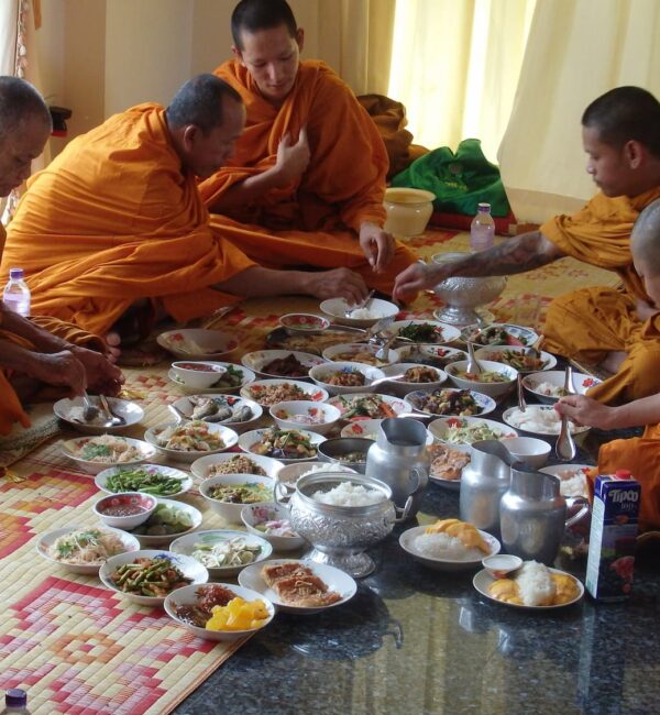 Monks eating during blessing