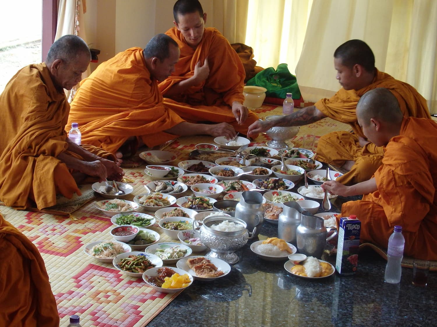 Monks eating during blessing